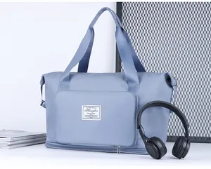 Close-up of blue large capacity travel bag featuring expandable zipper and front pocket