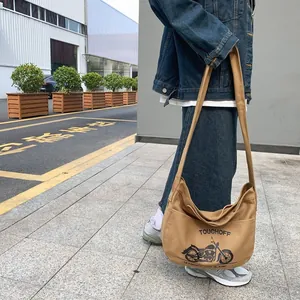 Khaki canvas crossbody bag with motorcycle print and wide strap for casual wear