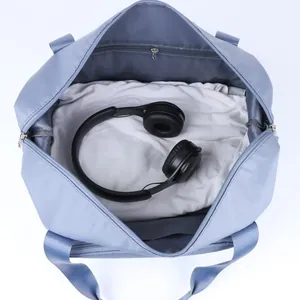 Spacious pale blue travel duffel bag showing large main compartment and inner zip pocket