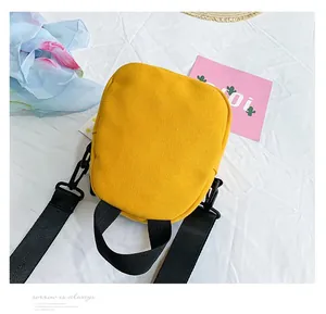 Detail of yellow canvas lunch bag with black handles in a casual Japanese style setting