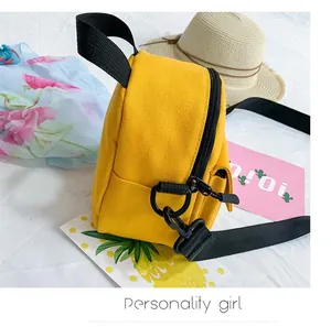 Detail of yellow canvas lunch bag with black nylon handle and metallic zipper