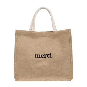 Sac cabas en jute avec imprimé merci et anses en coton tressé sur fond blanc