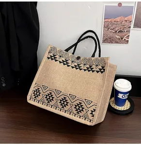 Detailed macro view of retro linen tote bag featuring geometric tribal patterns and button