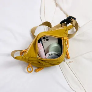 Detail view of mustard yellow nylon crossbody bag interior showing storage capacity