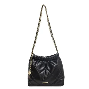 Chic black quilted leather bucket bag with gold chain strap and spherical pendant