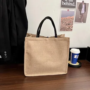 Minimalist jute tote bag with black round handles and natural linen texture for shopping