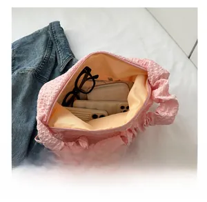 Capacité interne du sac rose à texture bulles montrant les objets du quotidien