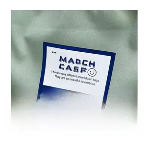 Detailed view of light green canvas fabric with a white rectangular brand label
