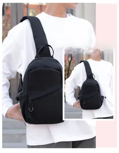 Detail of black waterproof nylon crossbody bag featuring an adjustable strap on model