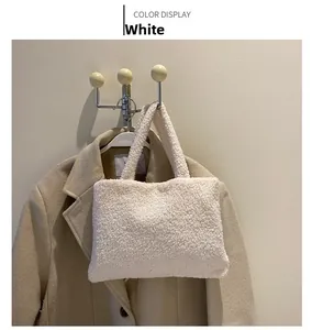 Close-up of the white fluffy faux shearling texture and thick material of the tote bag