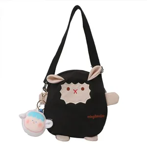 Sac bandoulière mignon en toile mouton noir avec sangle réglable et porte-clé poupée