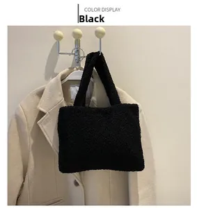 Detail of a black plush tote bag with sherpa texture against a beige coat background