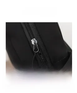 Detail view of durable black nylon bag showing zip closure and drawstring buckle