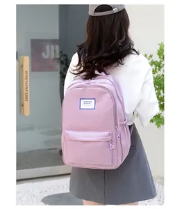 Detail of lavender nylon backpack with white square woven label and side pocket