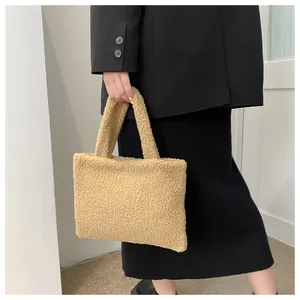 Detail of soft khaki plush tote bag with cozy fleece texture carried by a model