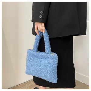 Detailed close-up of light blue plush tote bag with soft faux shearling texture