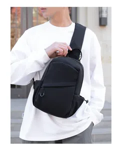 Close-up of minimalist black chest bag showing durable fabric and asymmetric stitching detail