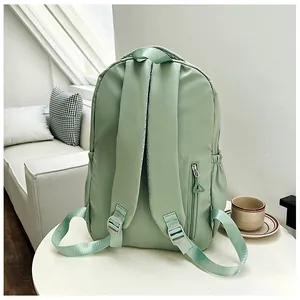 Detail of light green backpack back with padded straps and hidden anti-theft zipper pocket