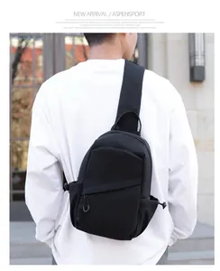 Detailed view of black nylon chest bag on model featuring drawstring and zipper pockets