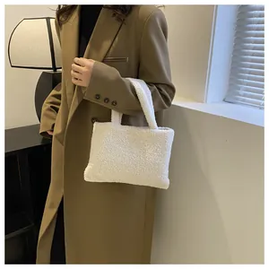 Detailed texture of white plush tote bag material on a brown coat background