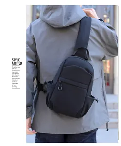 Detail of black waterproof crossbody bag featuring adjustable straps and side bungee pockets