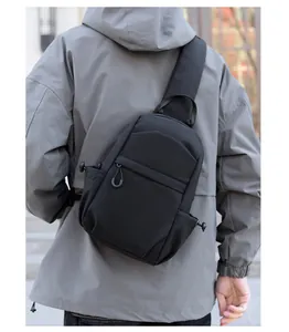 Outdoor view of a black multi-functional chest bag showing the actual wearing scale and fit