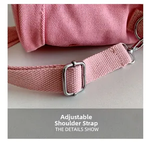 Dettaglio della borsa in tela rosa con tracolla in tessuto regolabile e fibbia in argento