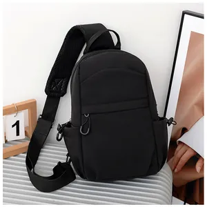 Detail of black crossbody chest bag with adjustable strap and breathable mesh padding