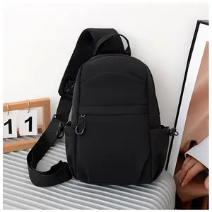Close-up of black crossbody bag showing breathable mesh shoulder strap and sturdy metal hooks
