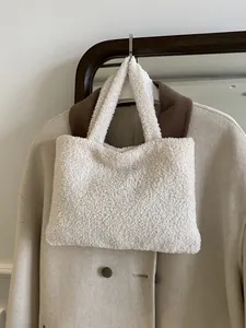 Minimalist beige plush tote bag with cozy fleece texture for casual winter styling