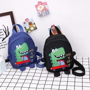 Detail view of blue and black cartoon dinosaur canvas bags with adjustable straps