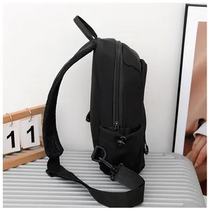 Detail of black waterproof nylon sling bag showing breathable mesh strap and drawstring pocket