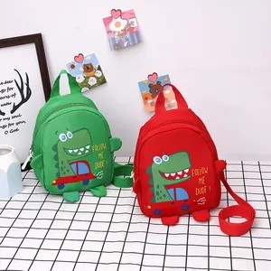 Detail of red and green dinosaur canvas bags for kids with adjustable strap and handles