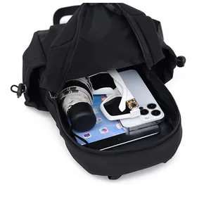 Internal view of black crossbody bag showing storage for tablet and umbrella