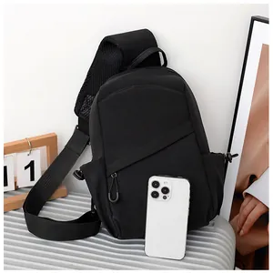 Detail of black crossbody chest bag featuring breathable mesh back and wide shoulder strap