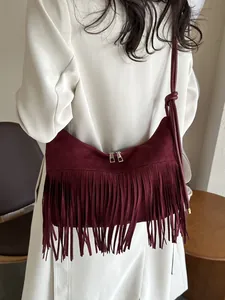 Elegant burgundy suede crossbody bag with long tassels and stylish double zippers