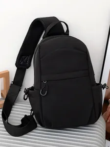 Versatile black chest bag with adjustable strap displayed on a suitcase for casual travel