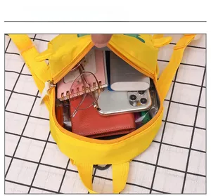 Internal view showing the spacious main compartment of the yellow toddler backpack