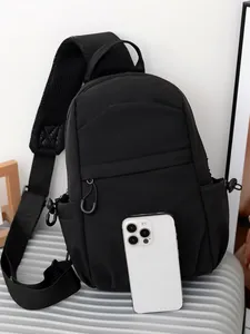 Black nylon crossbody chest bag with adjustable mesh strap and smartphone size reference