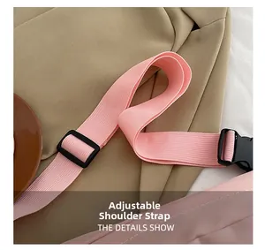 Detail of adjustable nylon shoulder strap with black plastic buckle for pink chest bag