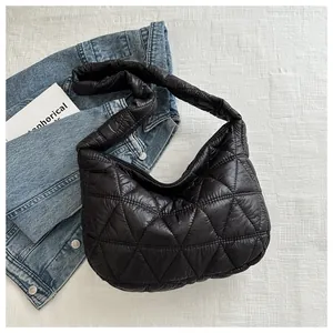 Detail view of black quilted puffer hobo bag with classic diamond stitching and wide strap