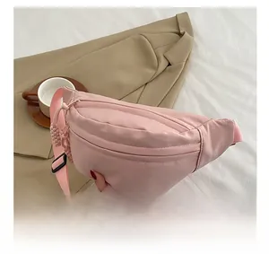 Detail of pink waterproof crossbody chest bag with adjustable strap and zip pocket