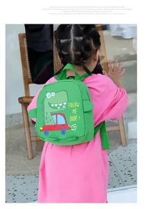 Close-up of green dinosaur toddler backpack with adjustable straps and side fin details