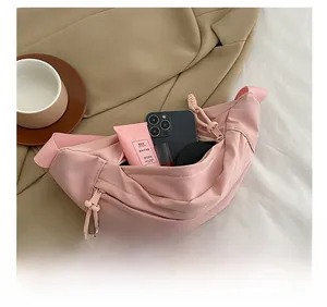 Internal view of pink nylon crossbody bag showing large capacity for daily essentials