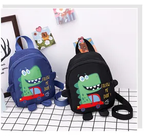 Detail view of cartoon dinosaur canvas messenger bags for kids in navy blue and black