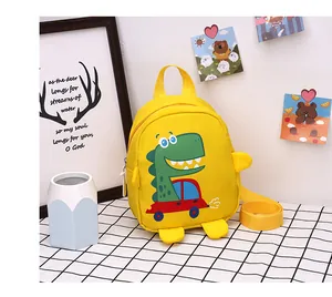 Detail of yellow canvas dinosaur bag featuring 'FOLLOW ME DUDE!' print and vibrant cartoon design