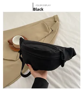 Detail view of a black minimalist nylon chest bag with woven zipper pull decoration