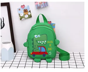 Detail of cartoon green dinosaur canvas bag with adjustable strap and carry handle
