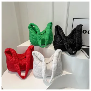 Quilted cloud shoulder bags displayed in green black red and white on white steps