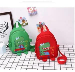 Detail of colorful canvas dinosaur cross-body bags for kids with adjustable straps